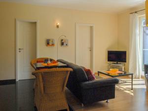 a living room with a couch and a table at Burg Roland Wohnung 04 in Dierhagen