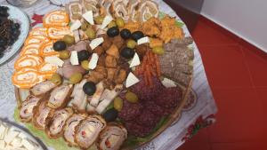 a platter of different types of food on a table at Casa Daria in Moisei