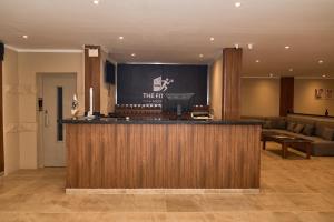 a hotel lobby with a bar and a couch at The Fit Stop Hostel in Hurghada