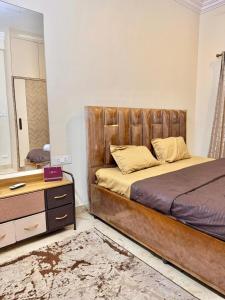 a bedroom with a large bed and a mirror at Dar E Noor in Hyderabad