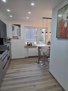 a kitchen with a table and a counter top at Kings Apartments in Ingolstadt +30 photos