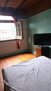 a bedroom with a bed and a window and a piano at hotel tango club in Buenos Aires +3 photos