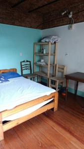 a bedroom with a bed and a table and chairs at hotel tango club in Buenos Aires