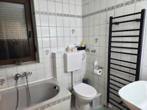 a bathroom with a toilet and a tub and a sink at AS Apartment Neukirchen-Vluyn in Neukirchen-Vluyn +17 photos