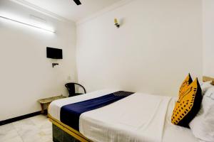 a bedroom with a bed and a tv in it at SPOT ON JAYAM RESIDENCY in Chennai