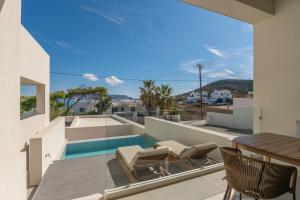 a view from the balcony of a house with a swimming pool at Etherio Suites Milos in Pollonia