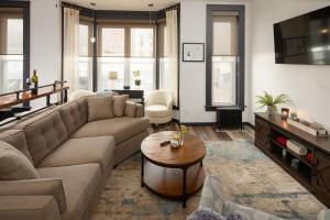 a living room with a couch and a table at The Alibi- We will cover for you in Port Clinton