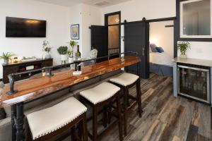 a bar with stools in a living room at The Alibi- We will cover for you in Port Clinton