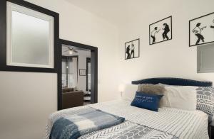 a bedroom with a bed and some pictures on the wall at The Alibi- We will cover for you in Port Clinton