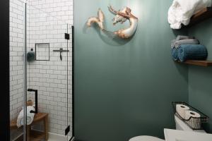 a bathroom with a shower with a seahorse on the wall at The Alibi- We will cover for you in Port Clinton +5 photos