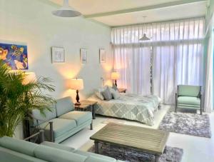a living room with a bed and a couch at 2nd floor loft with swimming pool in Oaxaca City +32 photos