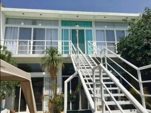 a building with a white staircase in front of it at 2nd floor loft with swimming pool in Oaxaca City