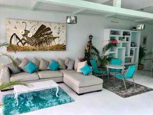 a living room with a couch and a spider painting on the wall at 2nd floor loft with swimming pool in Oaxaca City