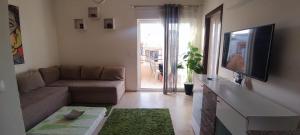 a living room with a couch and a flat screen tv at La douce in Sousse