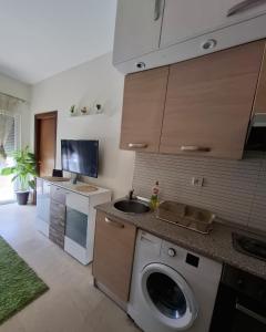 a kitchen with a sink and a washing machine at La douce in Sousse