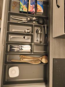a drawer filled with kitchen utensils in a refrigerator at Michas FeWo in Bautzen +10 photos
