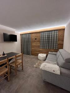 a living room with a couch and a table at Baita Piazza in Valdisotto
