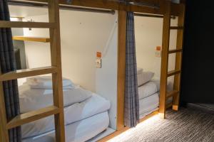 a room with two bunk beds and a ladder at CODE - The Loft, Edinburgh in Edinburgh