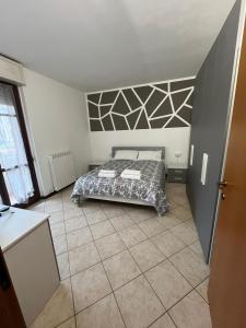 a bedroom with a bed in the middle of a room at AlbaChiara Apartment in Gallarate