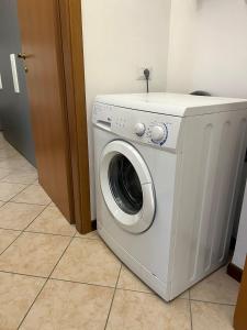 a white washing machine sitting in a room at AlbaChiara Apartment in Gallarate