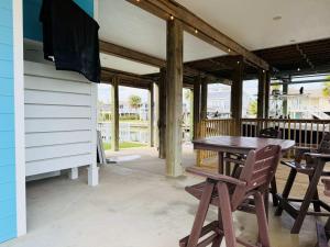 a wooden table and chairs on a patio at Dockside Dream Home for 10 in Galveston
