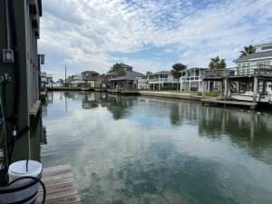 a body of water with houses and condos at Dockside Dream Home for 10 in Galveston
