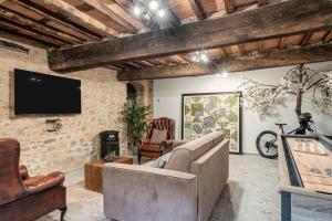 a living room with a couch and a tv at The Townhouse Barga in Barga