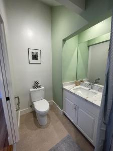 a bathroom with a toilet and a sink and a mirror at Santa Cruz Hostel in Santa Cruz