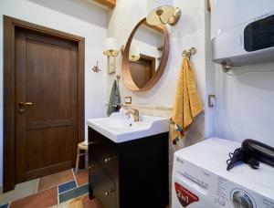 a bathroom with a sink and a mirror at Luxury OldTown Free Parking in Vilnius +5 photos