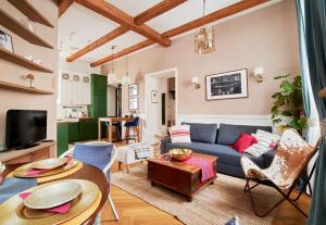 a living room with a blue couch and a table at Luxury OldTown Free Parking in Vilnius