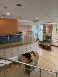 a lobby with a staircase in a building at Flat Moderno no Blue Tree Hotel in Manaus +9 photos