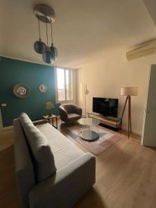 a living room with a couch and a television at San Clemente guest house in Padova