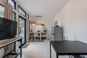 a kitchen with a black table and a refrigerator at Studio Kunst in Bangkok