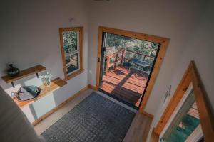 an empty room with a door leading to a deck at Off-Grid Tiny Home Pacific Views & Serenity in Pauma Valley