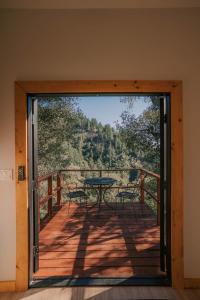 a door leading to a deck with a table and chairs at Off-Grid Tiny Home Pacific Views & Serenity in Pauma Valley