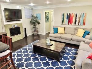 a living room with a couch and a coffee table at LB Peninsula Steps to Beach close to in Long Beach
