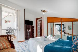 a bedroom with a bed and a living room at Due Passi Dal Mare in Torre a Mare