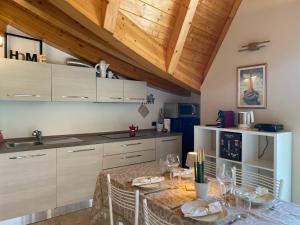 a kitchen with a table with wine glasses on it at APPARTAMENTO MONTE - VALANDRO- in Comano Terme