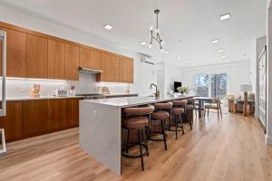 a kitchen with a large island with bar stools at Serengeti Suite in Downtown Eagle in Eagle