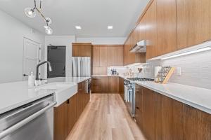 a large kitchen with wooden cabinets and white counter tops at Serengeti Suite in Downtown Eagle in Eagle +20 photos