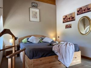 a bedroom with a bed and a mirror at APPARTAMENTO MONTE - VALANDRO- in Comano Terme
