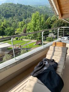 a black shirt sitting on a ledge on a balcony at APPARTAMENTO MONTE - VALANDRO- in Comano Terme