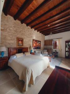 a bedroom with a large bed and a stone wall at Niki's House in Limassol