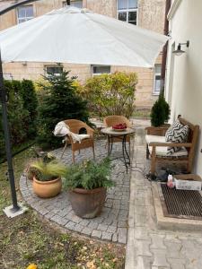 a patio with a table and chairs and an umbrella at Luxury OldTown Free Parking in Vilnius