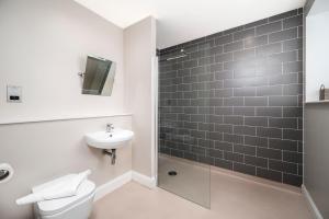 a bathroom with a toilet and a sink and a shower at Burnside, Dornoch in Dornoch