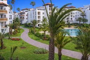 a view of a park with palm trees and buildings at Marina Executive Suites in Agadir