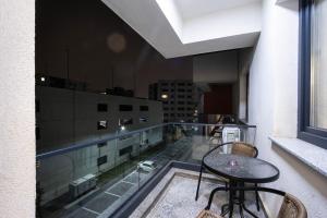 a balcony with a table and chairs on a building at Ivory Luxury 1BR in Voluntari