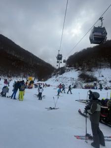 a group of people on a ski slope with a ski lift at Casa Al Colle in Pescocostanzo