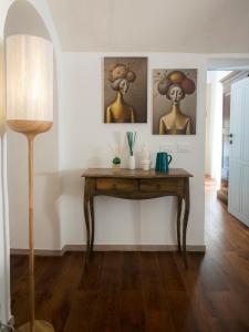 a table in a room with paintings on the wall at Profumo Antico - Luxury Guesthouse by STHEY in Monopoli +76 photos