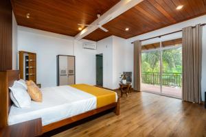 a bedroom with a bed and a large window at Talpe Paradise in Galle +36 photos